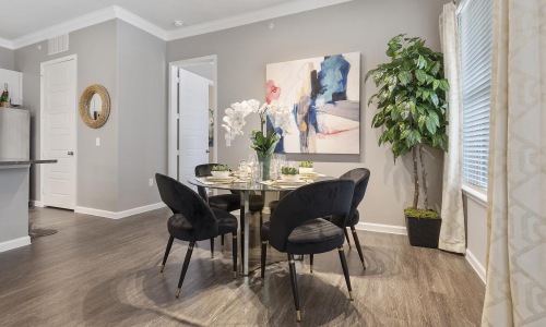 a dining room with a table and chairs