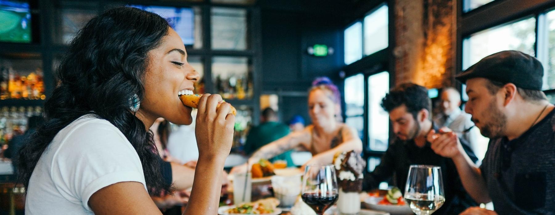 a group of people eating at a restaurant