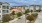 a group of buildings with trees and bushes in front of them