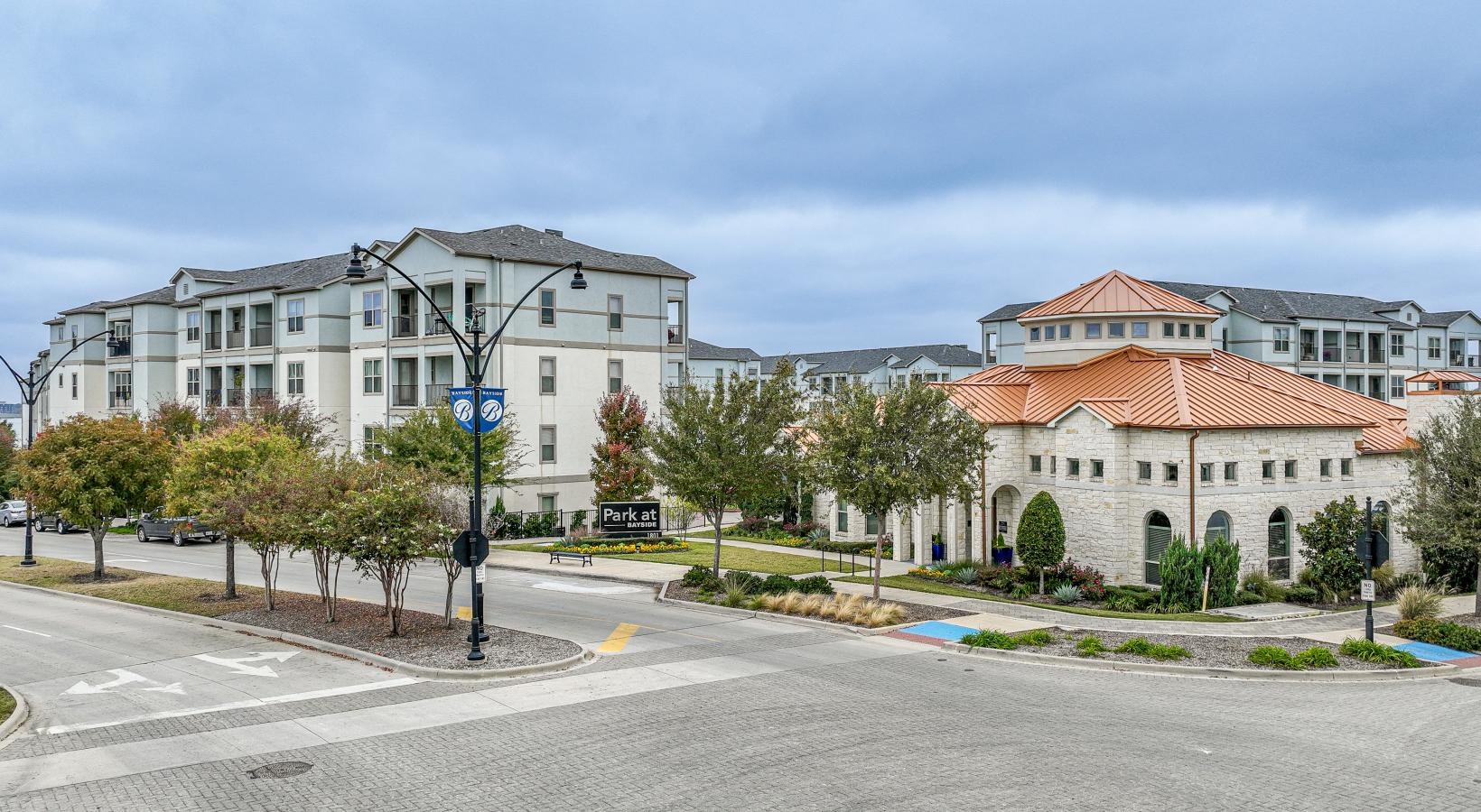 Settle into comfort at Park at Bayside a street with trees and buildings on the side
