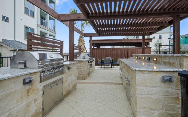 a large outdoor kitchen with grills