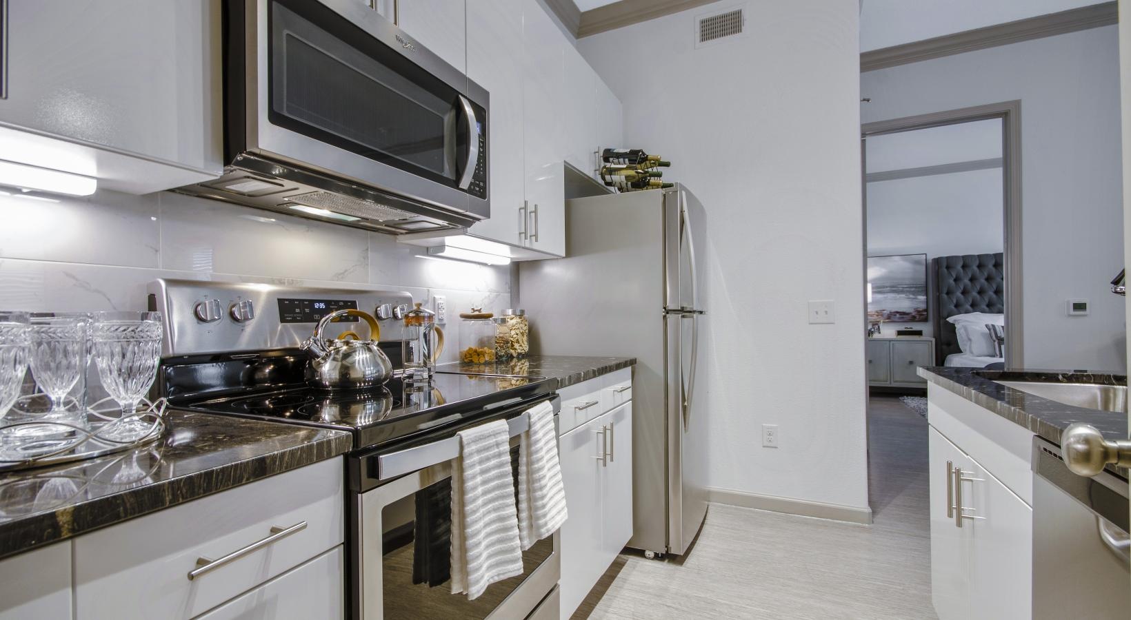 Spacious kitchens with thoughtful details a kitchen with white cabinets