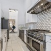 large clubhouse kitchen with white cabinets and stainless steel appliances