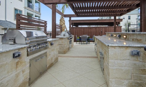 a large outdoor kitchen with grills