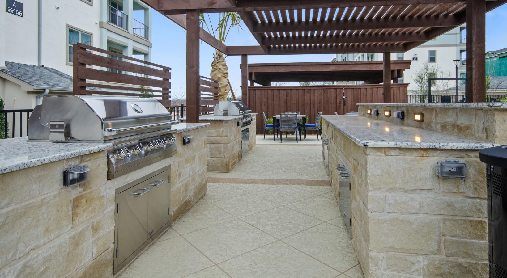 Settle into comfort at Park at Bayside a large outdoor kitchen with grills