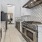 a kitchen with white tiles