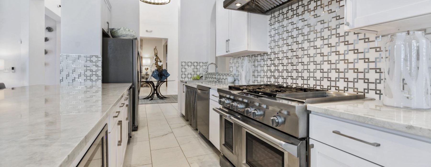 a kitchen with white tiles