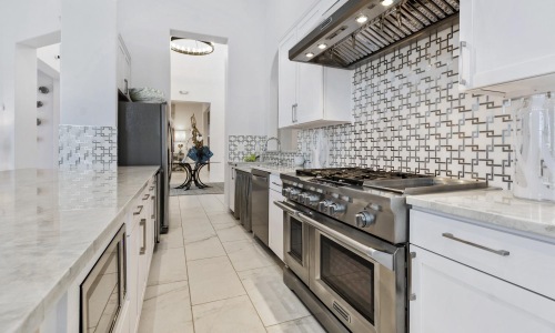a kitchen with white tiles
