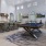 a room with a pool table and chairs